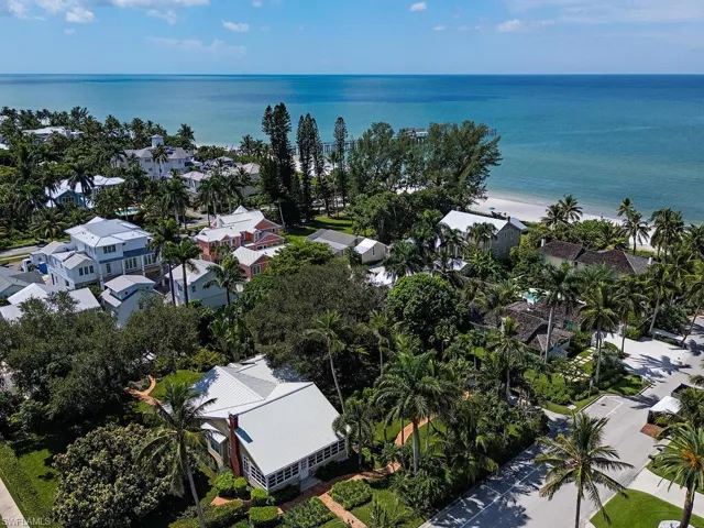 Aerial view of property's location featuring expansive coastline and nearby suburban area