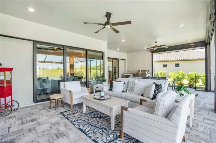 View of patio with ceiling fan, an outdoor living space, and area for grilling