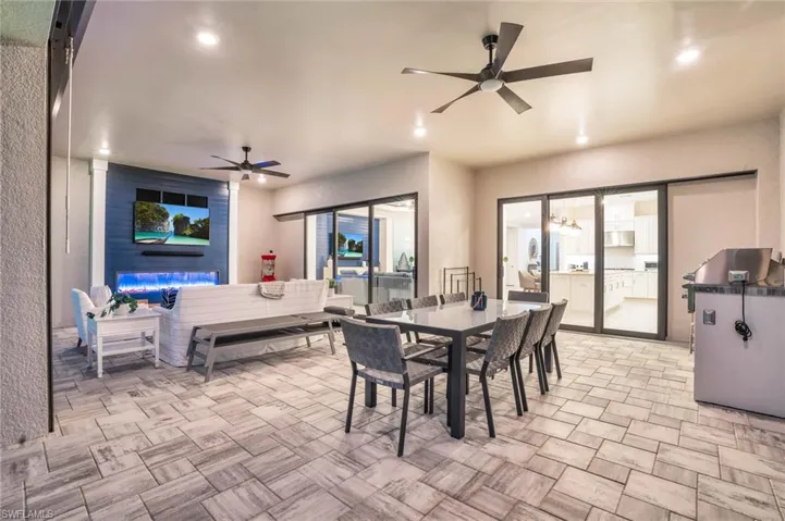 Dining space with ceiling fan and light tile patterned floors