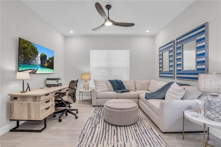Living room featuring ceiling fan and light wood-type flooring