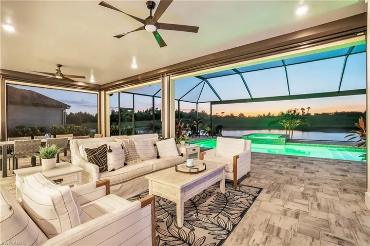 Patio terrace at dusk featuring ceiling fan, a lanai, and an outdoor living space