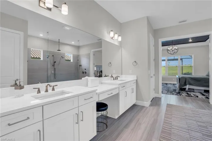 Bathroom featuring double vanity and walk in shower