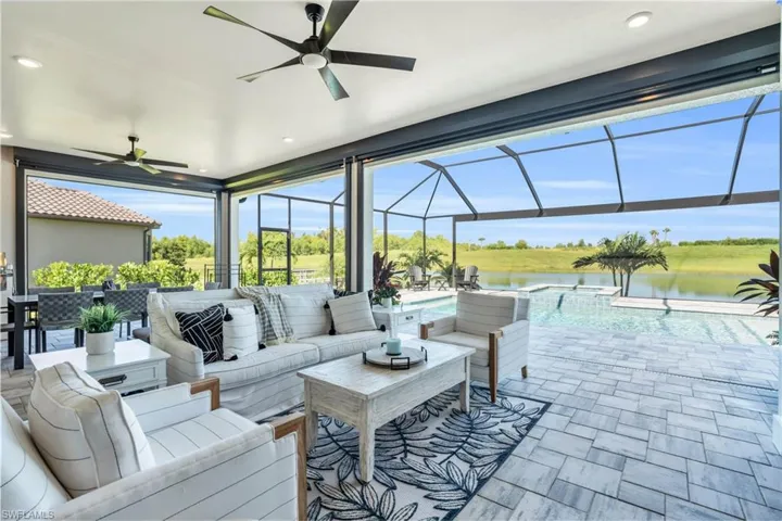 View of patio featuring ceiling fan, a water view, and an outdoor hangout area