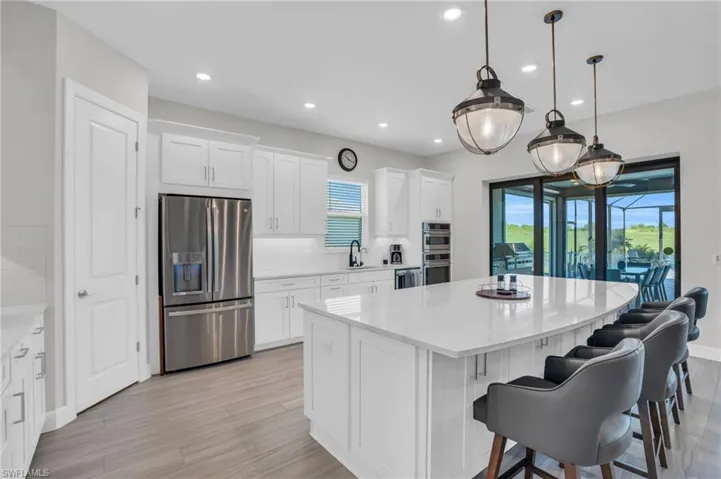 Kitchen with appliances with stainless steel finishes, backsplash, a kitchen island, and a wealth of natural light