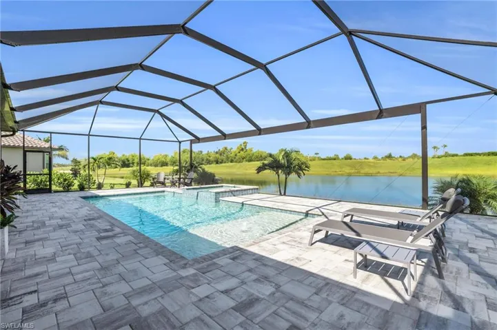 View of swimming pool featuring a lanai and a patio