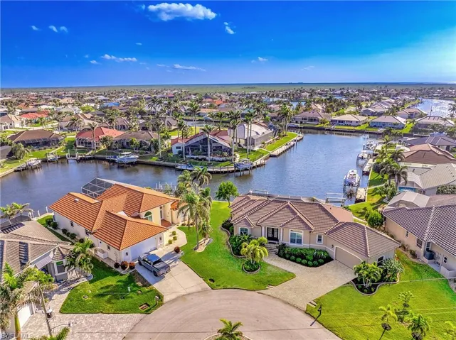 Birds eye view of property with a water view