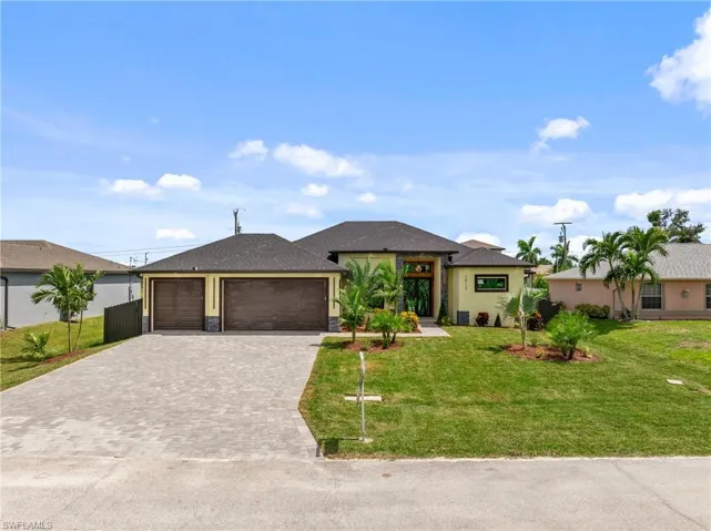 View of front of home featuring a garage and a front yard