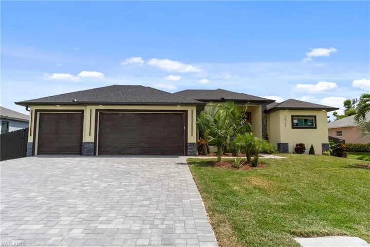 Prairie-style house featuring a three car garage and a front lawn