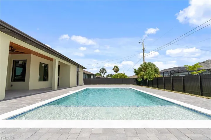 View of swimming pool featuring a patio and ceiling fan
