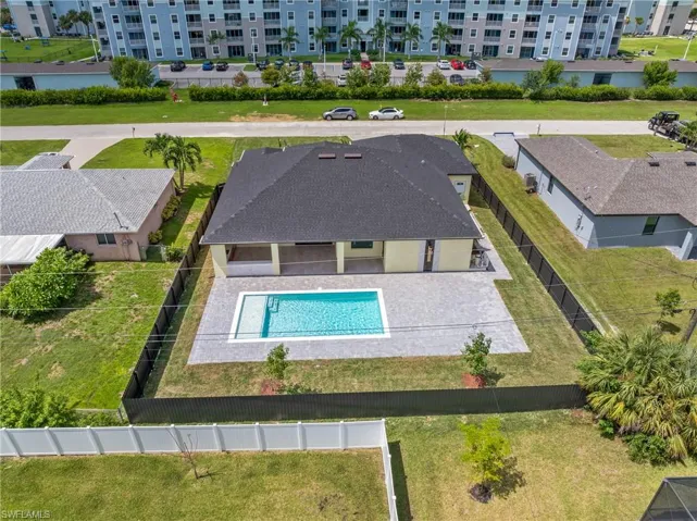 View of pool with a patio area and a yard