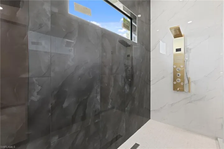 Bathroom featuring a tile shower