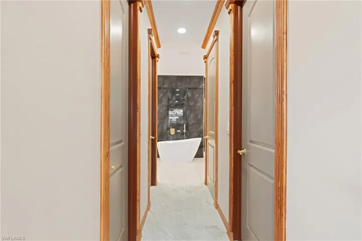 Hallway featuring crown molding
