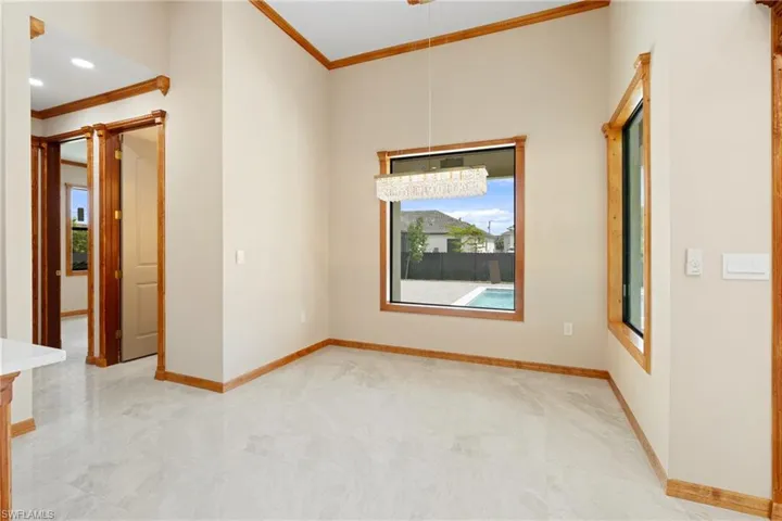Tiled empty room with crown molding