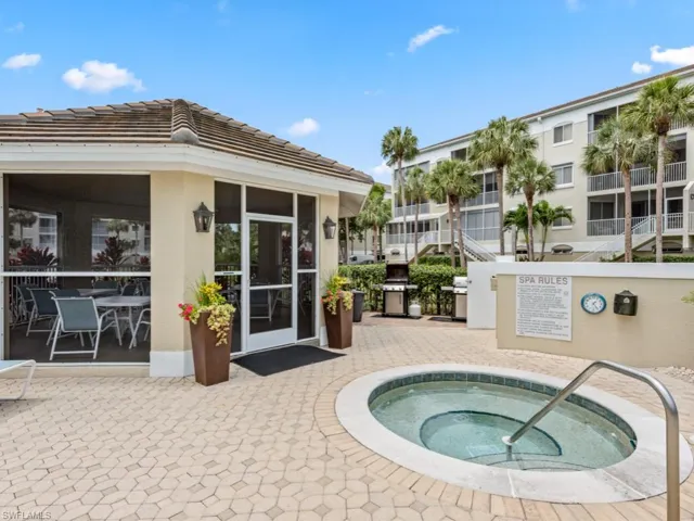 View of swimming pool with a patio, grilling area, and a hot tub