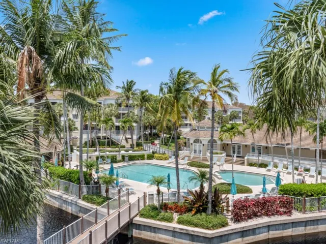 Community pool with fence and a patio