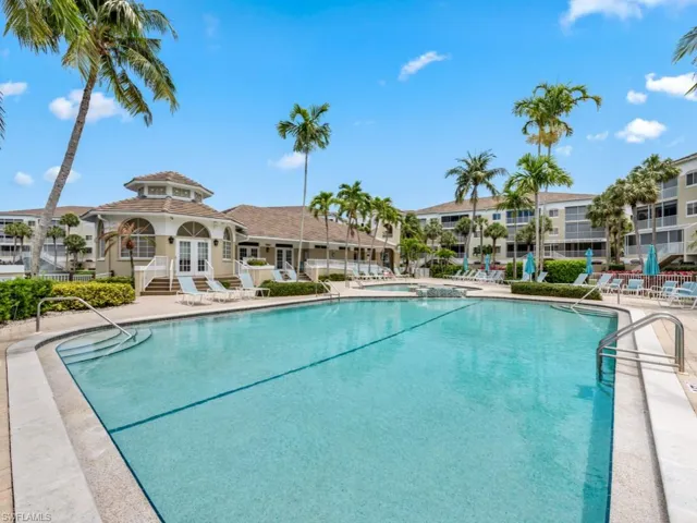 Pool with fence, french doors, and a patio