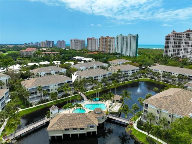 Birds eye view of property featuring a view of city and a water view