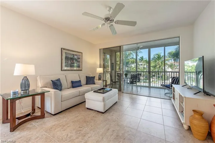 Living area with light tile patterned floors and a ceiling fan