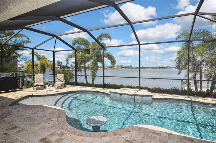 Pool featuring a patio area, a lanai, and a water view