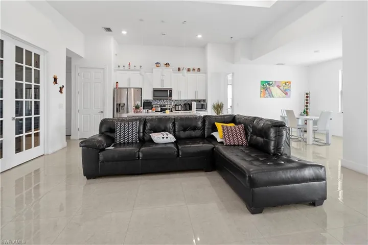 Living room with recessed lighting and a high ceiling