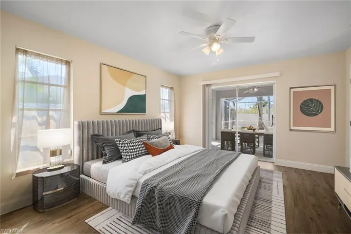 Bedroom featuring access to exterior, baseboards, and wood finished floors