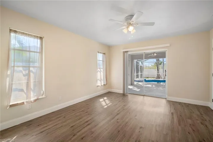 Empty room featuring ceiling fan, baseboards, and wood finished floors