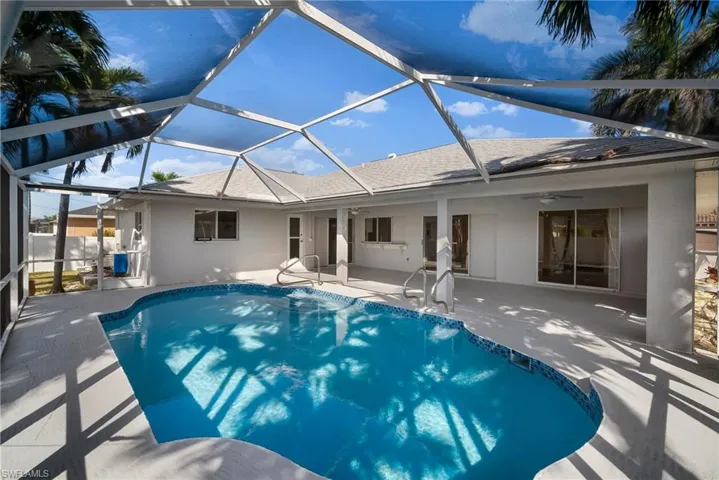 View of swimming pool with a fenced in pool, a lanai, a patio area, and ceiling fan
