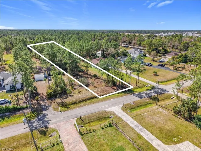 View of property location featuring property boundaries highlighted and a forest