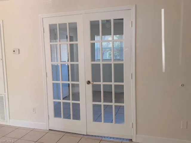 Doorway to outside with french doors and tile patterned floors