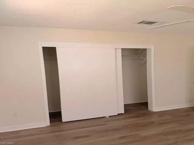 Unfurnished bedroom with light wood-type flooring and a closet
