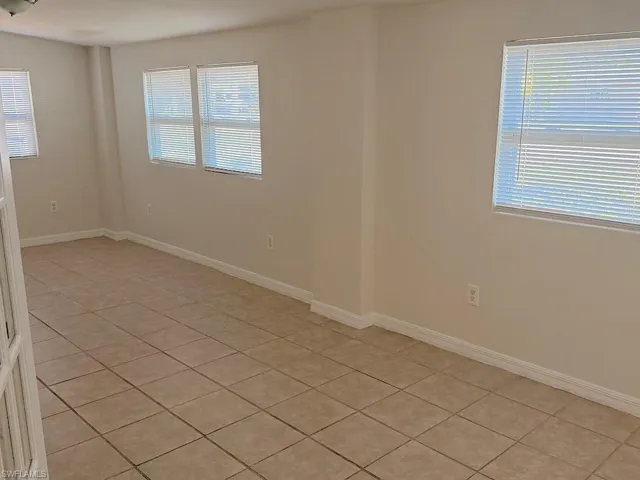 Unfurnished room with light tile patterned floors and healthy amount of natural light