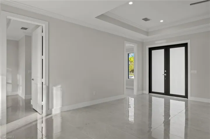 Unfurnished room featuring french doors and crown molding