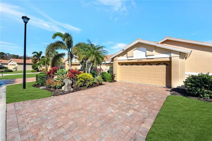 View of front of house featuring a garage and a front lawn