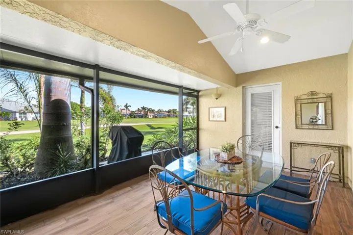 Sunroom / solarium with lofted ceiling and ceiling fan