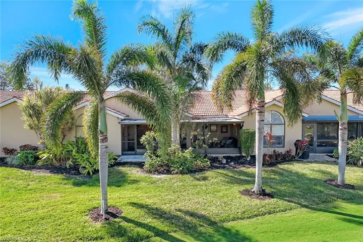 Mediterranean / spanish-style house featuring a sunroom and a front yard