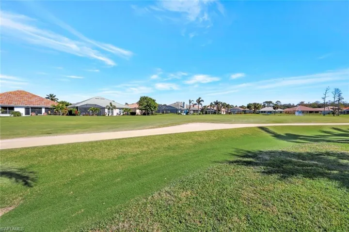 View of home's community with a yard