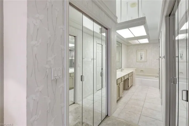 Bathroom featuring vanity, tile patterned floors, and plus walk in shower