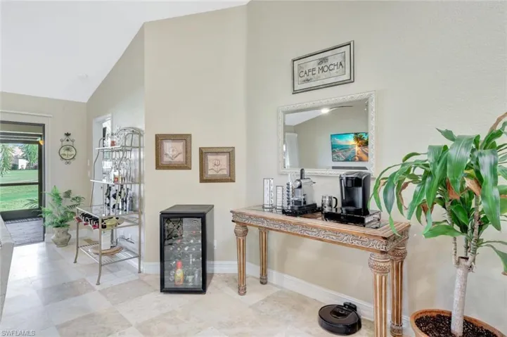 Hallway with beverage cooler and high vaulted ceiling