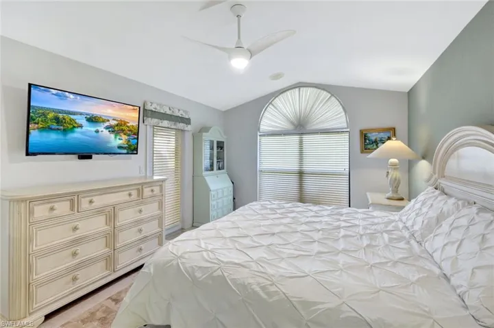 Bedroom featuring lofted ceiling and ceiling fan