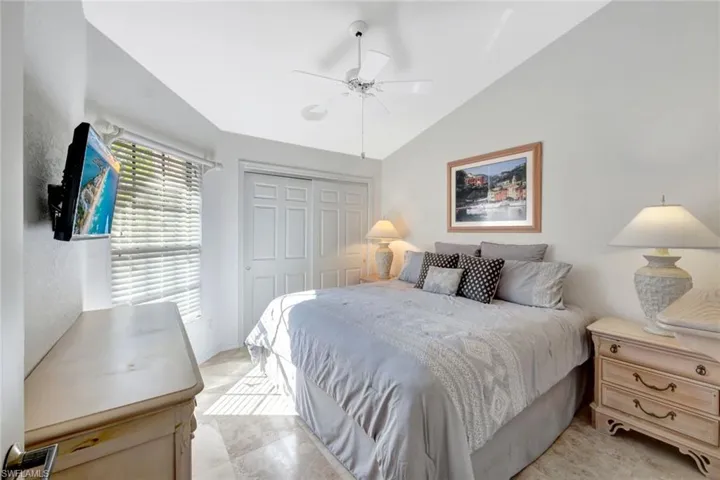 Bedroom featuring vaulted ceiling, a closet, and ceiling fan