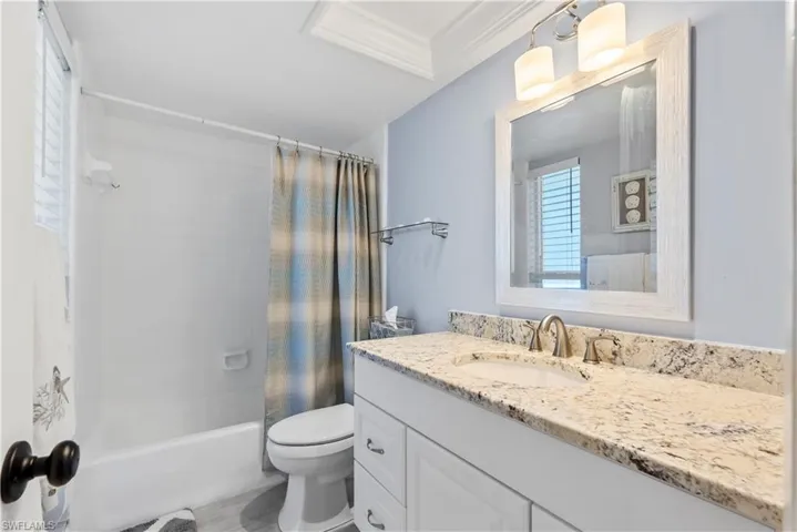 Full bath with vanity, shower/tub combo.