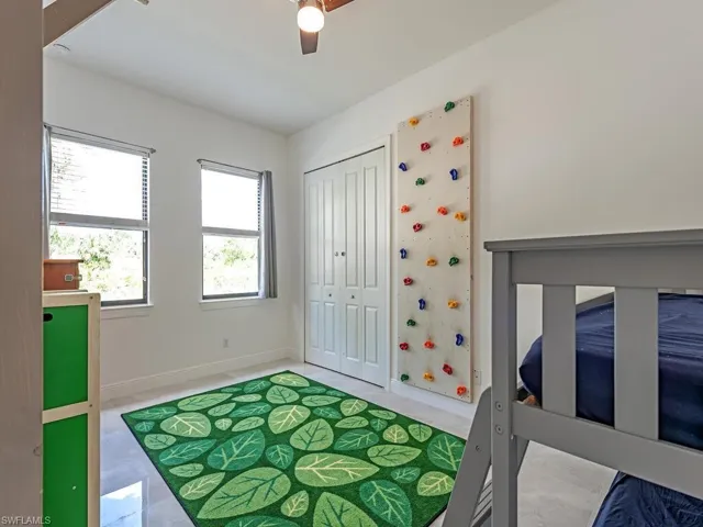 Bedroom with baseboards, ceiling fan, and a closet
