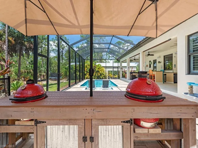 Swimming pool featuring a lanai, ceiling fan, and a patio area