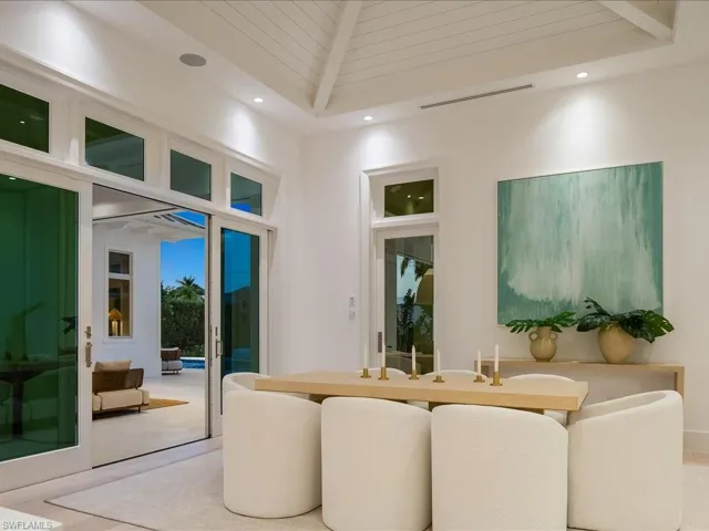 Dining space featuring a high ceiling, visible vents, and recessed lighting
