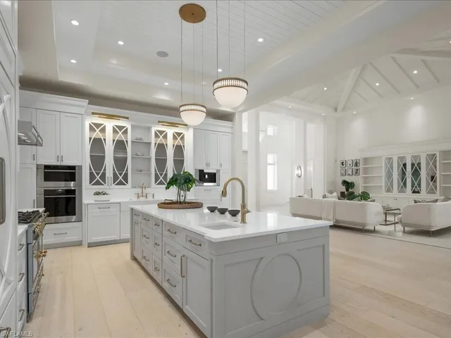 Kitchen with open floor plan, a sink, and light wood-type flooring