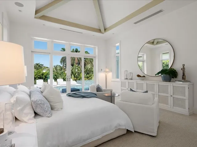 Bedroom featuring access to outside, visible vents, multiple windows, and beamed ceiling