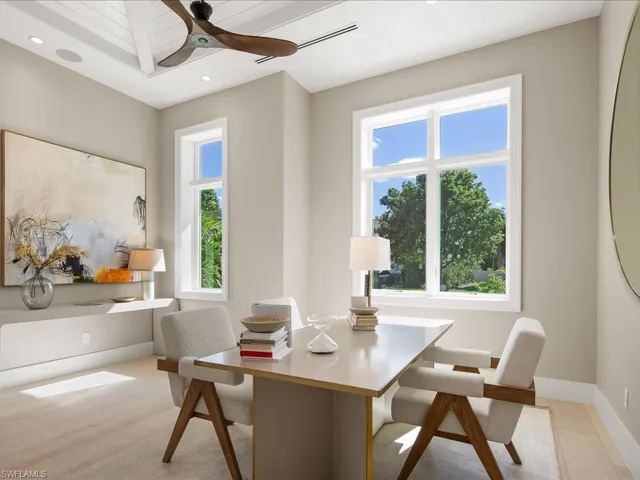 Office area with light wood finished floors, baseboards, ceiling fan, and recessed lighting