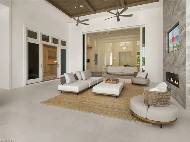Living room featuring a ceiling fan, wood ceiling, a premium fireplace, and recessed lighting