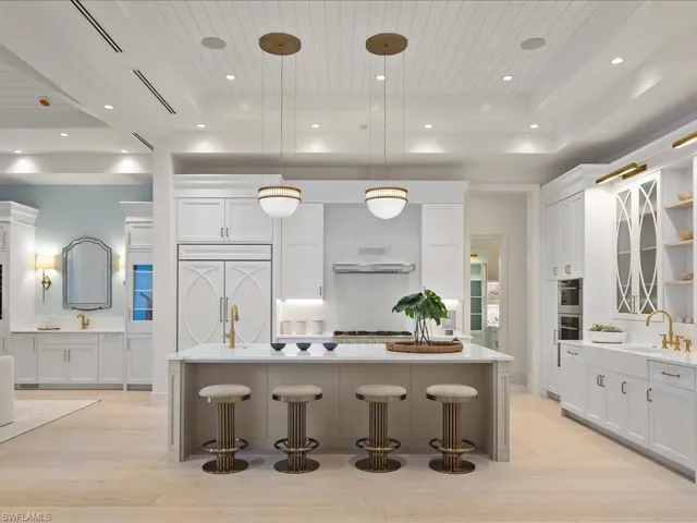 Kitchen featuring white cabinetry, a tray ceiling, paneled fridge, and wood ceiling