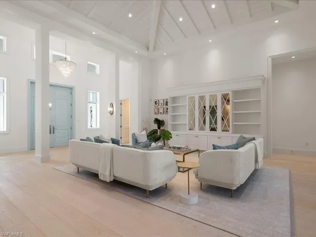 Living room with light wood-type flooring, high vaulted ceiling, wood ceiling, beam ceiling, and visible vents